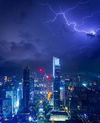 Night cityscape of guangzhou urban skyscrapers at storm with lightning  bolts in night purple blue...