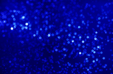 abstract blue bokeh bright glitter sparkle glowing background. for template web advertising design brand, backdrop, party, new year christmas celebration etc.