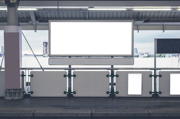 billboard big blank white LED screen horizontal outstanding in subway side pathway people walking to train underground for display advertisement text template promotion new brand indoor.