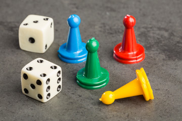 colorful play figures with dice on board