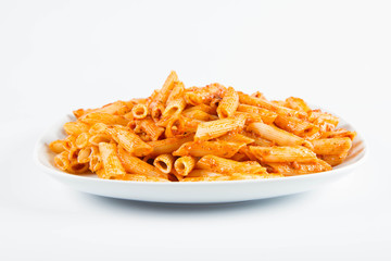 Penne with pesto on a plate on a white background