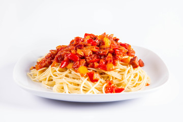 Spaghetti with sauce on a plate on a white background