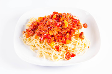 Spaghetti with sauce on a plate on a white background