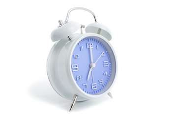 Twin bells analogue alarm clock with blue clock face shows seven o’clock, 7 AM PM; concept on white background