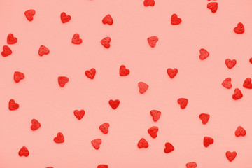 design concept of trendy color living coral sweet sprinkles of heart shapes like background, concept of St. Valentines Day