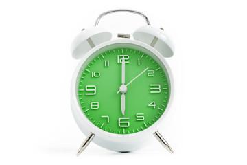 Twin bells analogue alarm clock with green clock face shows six o&rsquo;clock, 6 AM PM; concept on white background