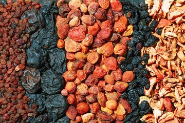 Healthy food. Background of dried fruit. Rows of dried apricots, pears, raisins, apples, prunes