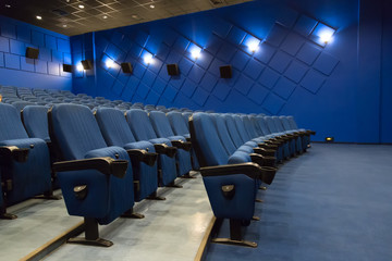 Empty cinema auditorium. Empty rows of blue theater or movie seats