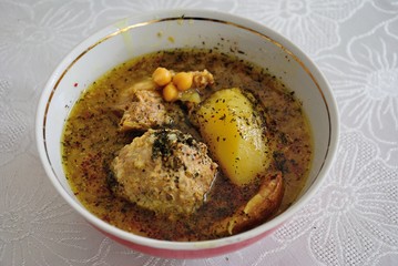 Traditional Azerbaijani Kufta bozbash -  pea soup with lamb meatballs, made of minced meat and rice, zesty dried plum inside and boiled potatoes topped with dried mint and sumac