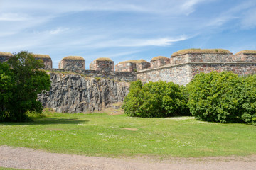 Granite walls of the historic fort Suomenlin Sveaborg in Finland on a summer day.