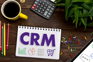 Notebook with a notes CRM on the office table with tools.