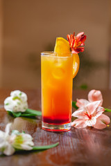 Tequila sunrise cocktail on wooden table. Close up