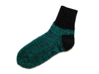 Black and green striped pattern isolated hand made hand knitted warm winter wool sock accessory on the white background