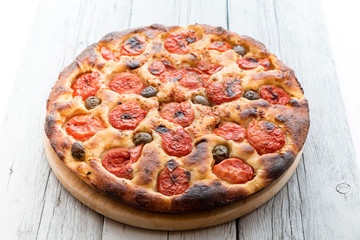 Focaccia typical of Bari Italy with tomatoes and olive