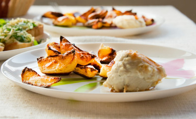 toast fried in oil, grated with garlic, smeared with mayonnaise and sprinkled with cheese, potatoes fried with slices and chicken roll on skewer
