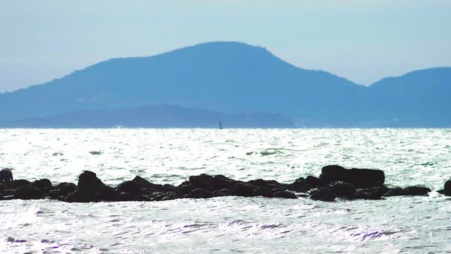 sea ebb, rocky seashore after low tide against a blue sky and clouds. seascape