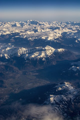 Fototapeta premium Swiss Alpes with snowy mountain tops aerial