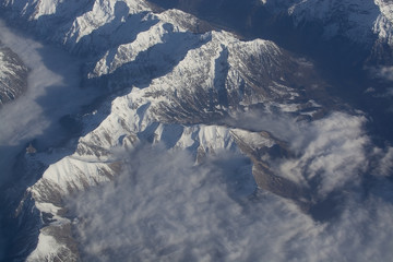Fototapeta premium Swiss Alpes with snowy mountain tops aerial