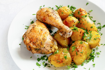chicken leg and tight garnished with potato and decorated with parsley