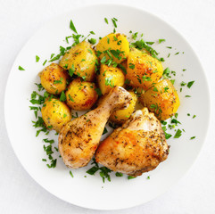 roasted with herbs potato and chicken leg and tight decorated with parsley
