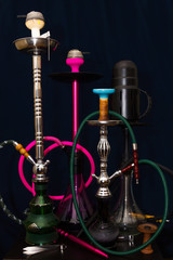 four different hookahs on the table on a dark blue background