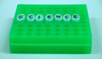 Test tube in a green laboratory rack labeled "science"