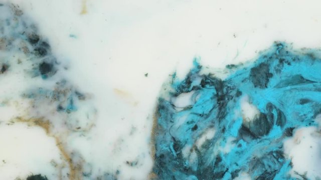 Colorful paint in bubbles organically moves in the liquid