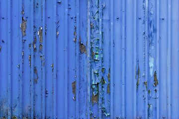 blue metal wall.it's got old peeling paint on it.Peeling paint on wall.cargo container