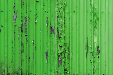 green wall.it's got old peeling paint on it.Peeling paint on wall.cargo container