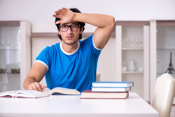 Young handsome student studying at home 