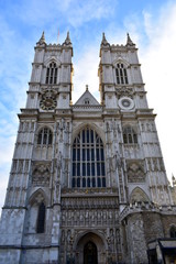 Fototapeta na wymiar Westminster Abbey. West gothic facade and towers with clock, windows and statues. London, United Kingdom.