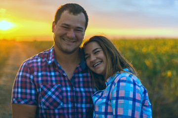 Young romantic couple in a field of sunflowers, pregnant girl in sunflowers	