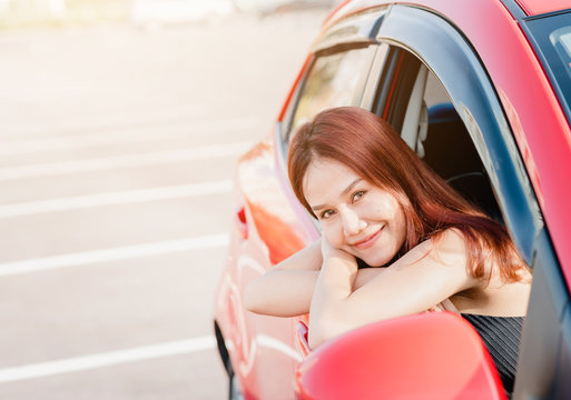 Asian Woman Driver In Red Car