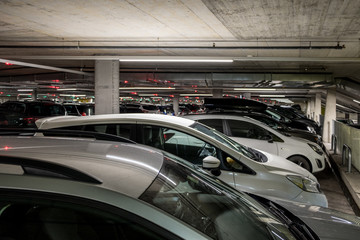 Full car park with red and green lights with a lot of cars