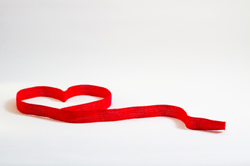 Heart-shaped ribbon on white background