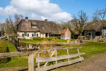 Early spring view on Giethoorn, Netherlands, a traditional Dutch village with canals and rustic thatched roof farm.