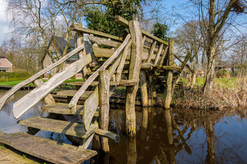 Fototapeta na wymiar Early spring view on Giethoorn, Netherlands, a traditional Dutch village with canals and old wooden bridges.