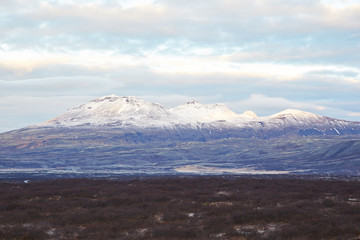 Thingvallavatn lake with reflection of sun during winter near sunrise