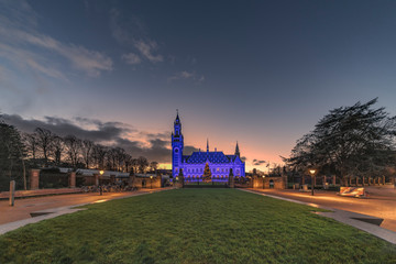 THE HAGUE, 10 December 2018 - Sunset behind the blue lighted Peace Palace celebrating the 70th...