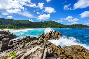 Fototapeta na wymiar water fountain over granite rocks,wild tropical beach with palms, seychelles 6