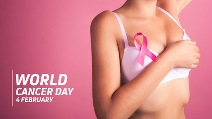 World cancer day concept background. Young woman examining her breast for lumps or signs of breast...