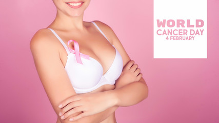 World cancer day concept background. Young woman examining her breast for lumps or signs of breast cancer. Pink Ribbon.
