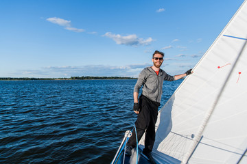 Handsome man resting On Yacht in the open sea on cruise.