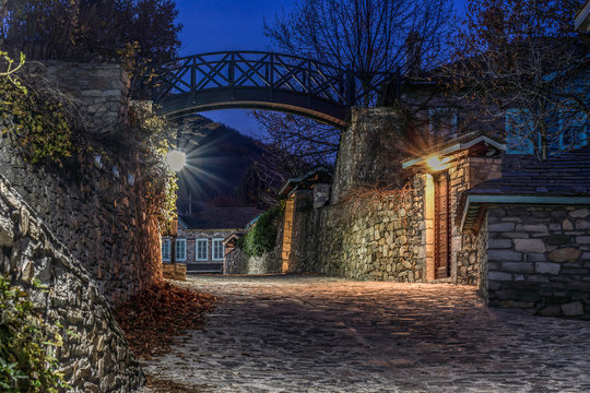 Traditional stone-built houses in the village of Nymfaio. There is a small bridge in the background. Night photo. HDR