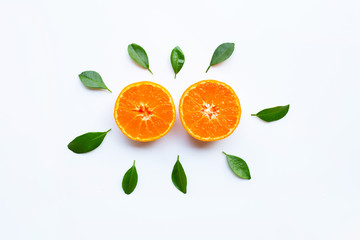 Orange fruits and green leaves on a white background.