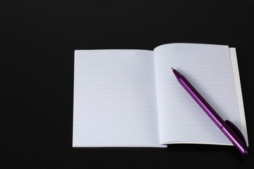 Notepad and pen on black background. Business / Finance / School concept. Business / Finance /School backgrounds.