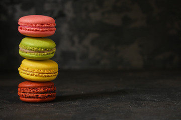 macaron or macaroon cake, colorful cookies (dark background). copy space