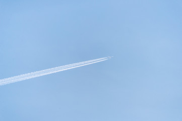 The liner flies in the blue sky and leaves a trace