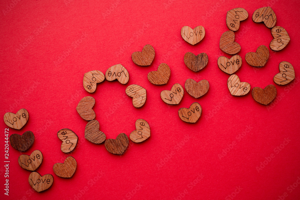 Wall mural The word love is laid out from a variety of wooden hearts