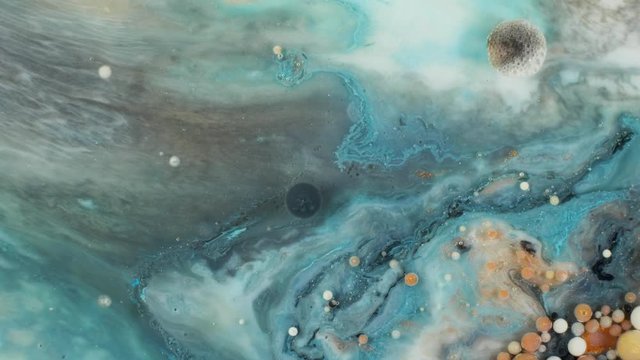 Colorful paint in bubbles organically moves in the liquid